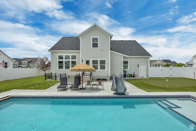 207 S Summer Breeze Ln, Layton, UT 84041 - back of house with an area to practice putting, a patio area, board and batten siding, and roof with shingles