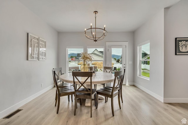 207 S Summer Breeze Ln, Layton, UT 84041 - dining area with light wood finished floors, a chandelier, plenty of natural light, and baseboards