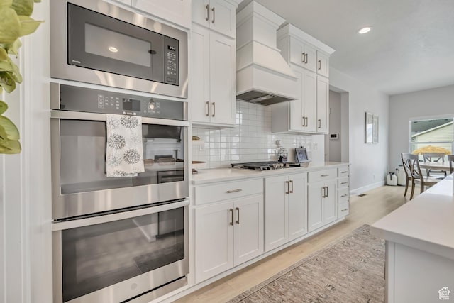 207 S Summer Breeze Ln, Layton, UT 84041 - kitchen featuring custom range hood, appliances with stainless steel finishes, tasteful backsplash, light countertops, and recessed lighting