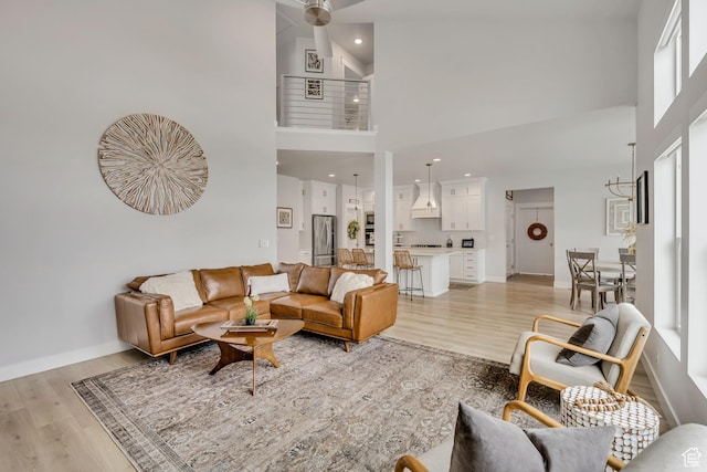 207 S Summer Breeze Ln, Layton, UT 84041 - living area with a high ceiling, light wood-style floors, recessed lighting, and baseboards