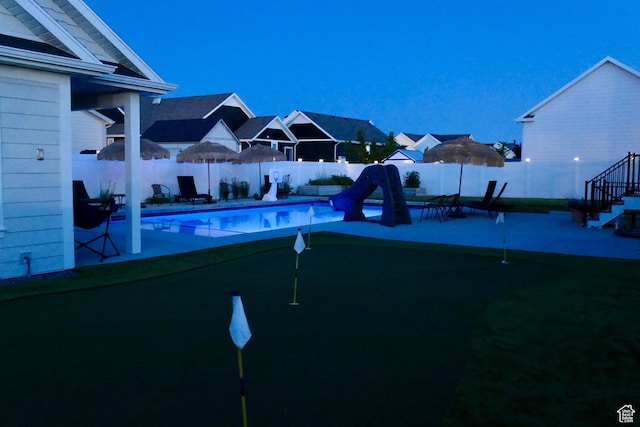 207 S Summer Breeze Ln, Layton, UT 84041 - view of pool with a putting green, a water slide, a fenced backyard, and a patio