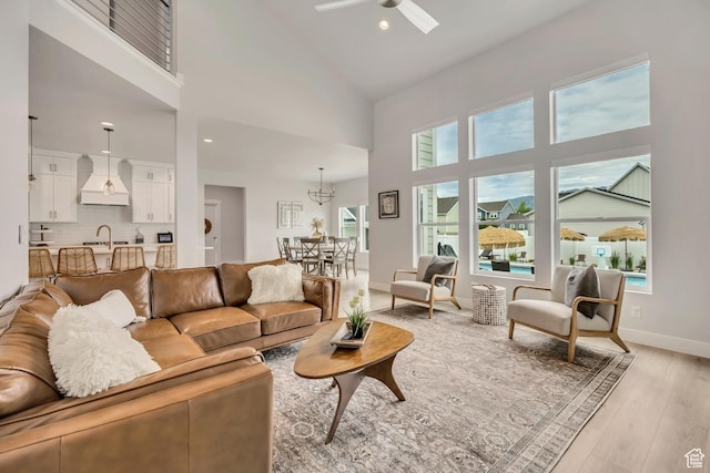 207 S Summer Breeze Ln, Layton, UT 84041 - living area featuring ceiling fan, high vaulted ceiling, light wood-type flooring, healthy amount of natural light, and baseboards