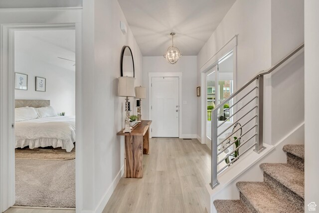 207 S Summer Breeze Ln, Layton, UT 84041 - entryway featuring stairs, baseboards, a chandelier, and light wood finished floors
