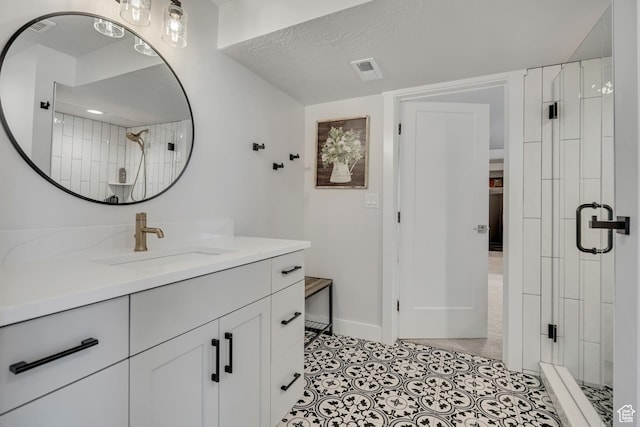 207 S Summer Breeze Ln, Layton, UT 84041 - bathroom featuring a stall shower, vanity, baseboards, and tile patterned flooring
