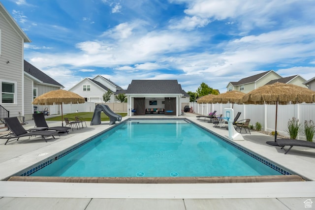 207 S Summer Breeze Ln, Layton, UT 84041 - view of pool with a water slide, a fenced backyard, a patio area, and an exterior structure