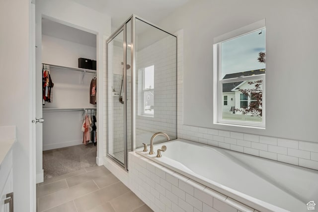207 S Summer Breeze Ln, Layton, UT 84041 - bathroom featuring a shower stall, a garden tub, tile patterned floors, a spacious closet, and plenty of natural light