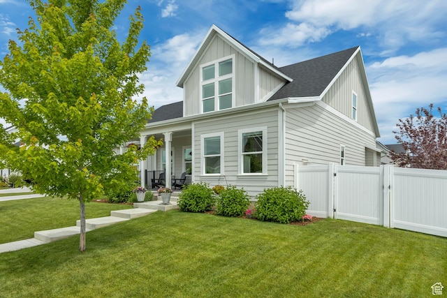 207 S Summer Breeze Ln, Layton, UT 84041 - view of front of home with board and batten siding, a porch, a gate, and roof with shingles