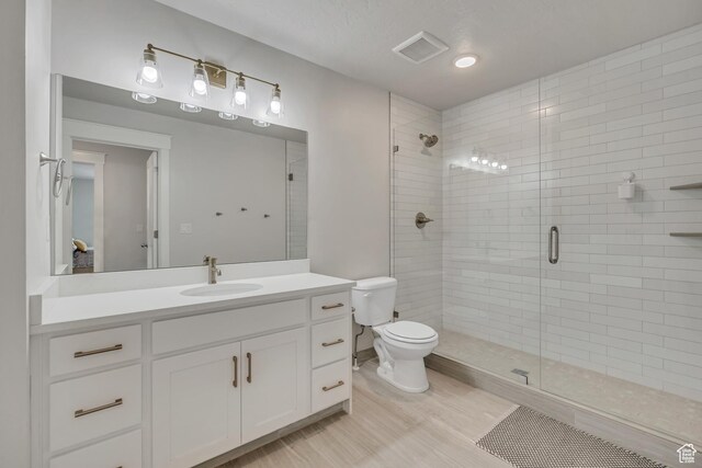 207 S Summer Breeze Ln, Layton, UT 84041 - bathroom with a stall shower, vanity, toilet, and wood finished floors