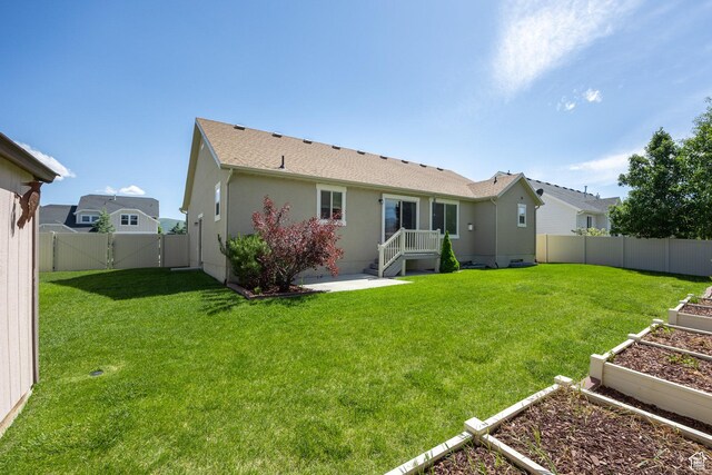 1015 E 650 S, Heber City, UT 84032 - back of property with a garden, a gate, and stucco siding