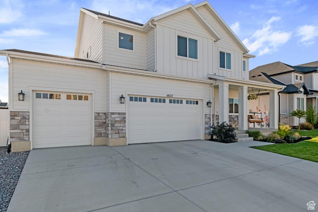 4827 N Sage Dr, Eagle Mountain, UT 84005 - view of front of home featuring stone siding, board and batten siding, concrete driveway, and a porch