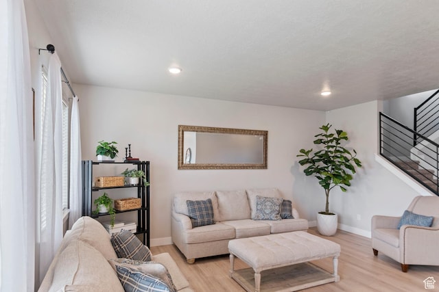 4827 N Sage Dr, Eagle Mountain, UT 84005 - living area featuring light wood finished floors, stairway, baseboards, and recessed lighting
