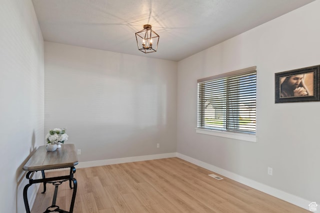 4827 N Sage Dr, Eagle Mountain, UT 84005 - spare room featuring light wood-style floors, a chandelier, and baseboards