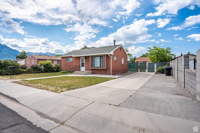 425 W 600 N, Orem, UT 84057 - ranch-style home featuring brick siding, a gate, a mountain view, and concrete driveway