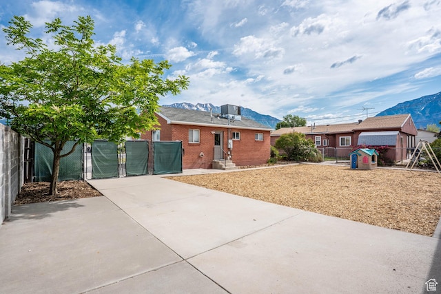425 W 600 N, Orem, UT 84057 - view of front of house featuring a mountain view, brick siding, a gate, and entry steps