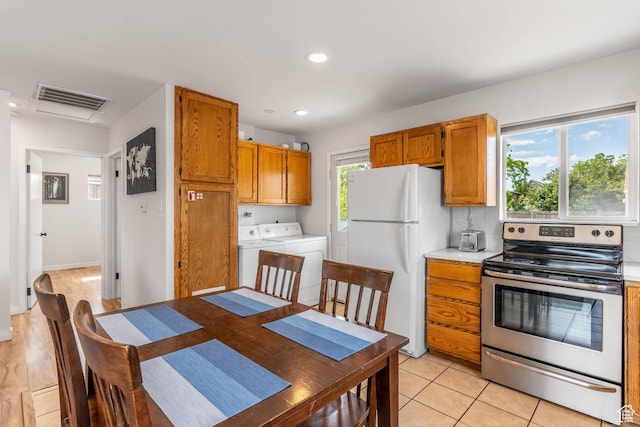 425 W 600 N, Orem, UT 84057 - kitchen featuring stainless steel range with electric stovetop, freestanding refrigerator, washer and dryer, light countertops, and brown cabinetry