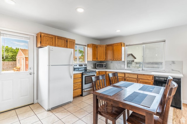 425 W 600 N, Orem, UT 84057 - kitchen with appliances with stainless steel finishes, a sink, light countertops, brown cabinetry, and recessed lighting