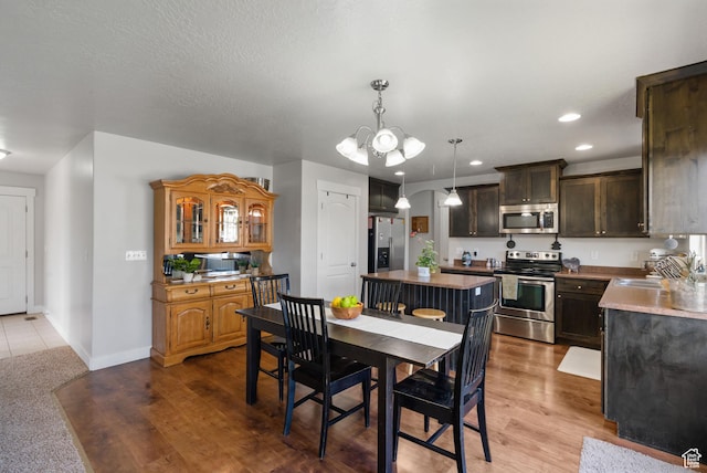 78 W Wildflower Dr, Saratoga Springs, UT 84045 - dining space with a chandelier, recessed lighting, baseboards, and wood finished floors