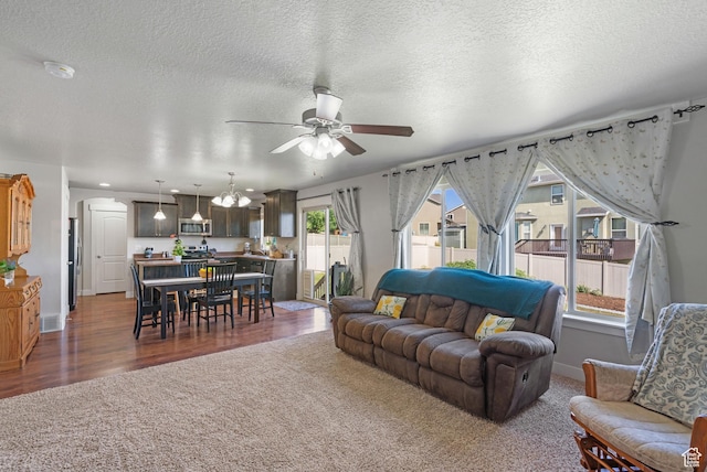78 W Wildflower Dr, Saratoga Springs, UT 84045 - living room featuring a ceiling fan, carpet, a chandelier, a textured ceiling, and wood finished floors