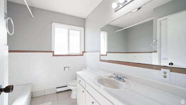 143 E 100 N, Gunnison, UT 84634 - bathroom featuring toilet, a tub to relax in, vanity, baseboard heating, and a wainscoted wall