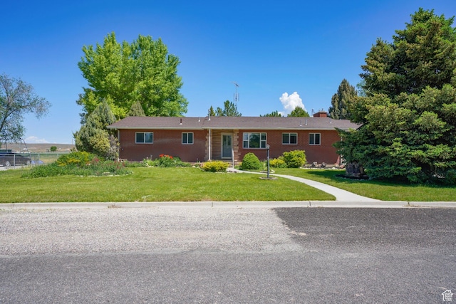 143 E 100 N, Gunnison, UT 84634 - single story home featuring a front yard, brick siding, and a chimney