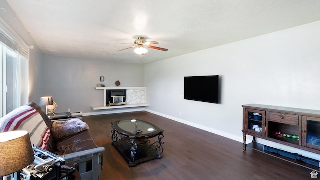 143 E 100 N, Gunnison, UT 84634 - living area featuring ceiling fan, wood finished floors, baseboards, and a glass covered fireplace