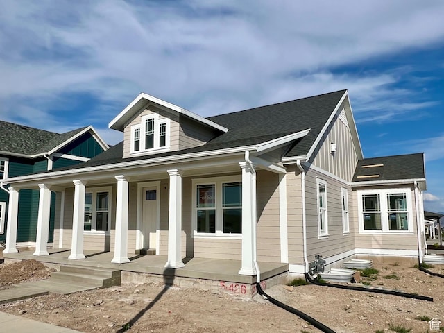 11129 S Bingham Rim Rd W Unit 5-426, South Jordan, UT 84009 - view of front facade featuring a porch, board and batten siding, and a shingled roof