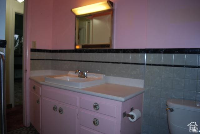 385 E 300 N, Spanish Fork, UT 84660 - bathroom with tile walls, vanity, toilet, and a wainscoted wall