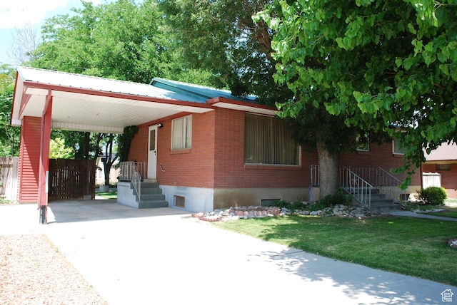 385 E 300 N, Spanish Fork, UT 84660 - view of front of home with concrete driveway, brick siding, and a carport
