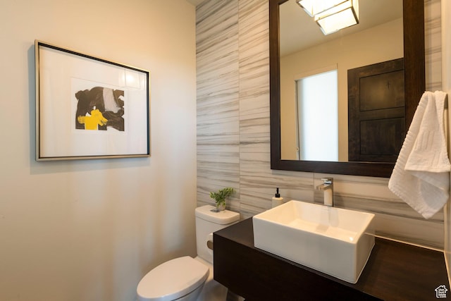 6650 Golden Bear Loop, Park City, UT 84098 - bathroom with tile walls, toilet, vanity, and tasteful backsplash
