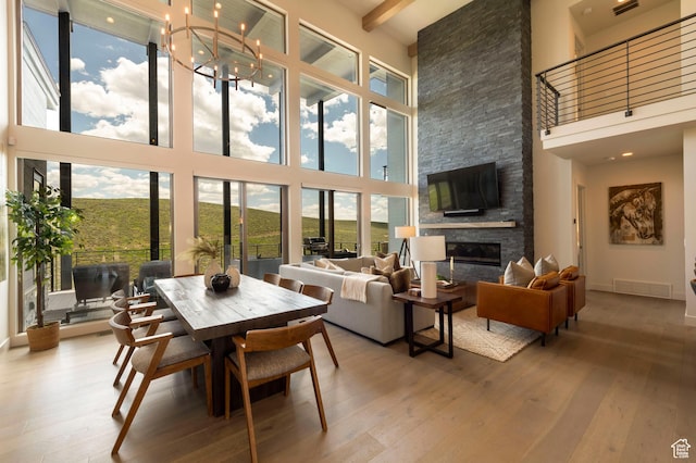6650 Golden Bear Loop, Park City, UT 84098 - dining space with a towering ceiling, hardwood / wood-style flooring, healthy amount of natural light, a stone fireplace, and beamed ceiling