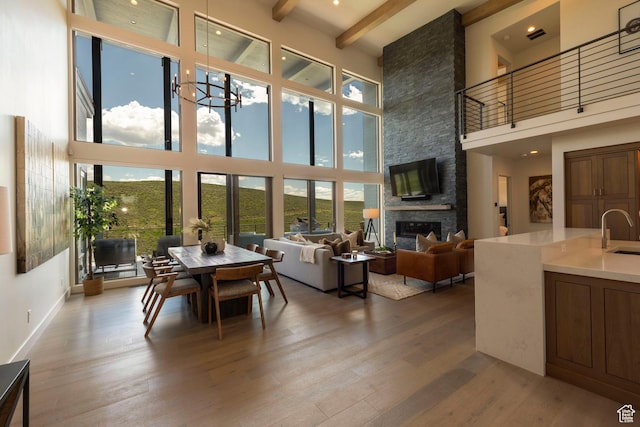 6650 Golden Bear Loop, Park City, UT 84098 - dining area featuring a towering ceiling, wood finished floors, a fireplace, beam ceiling, and baseboards