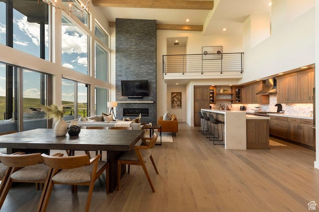 6650 Golden Bear Loop, Park City, UT 84098 - dining room with a towering ceiling, light wood-type flooring, a stone fireplace, beam ceiling, and recessed lighting