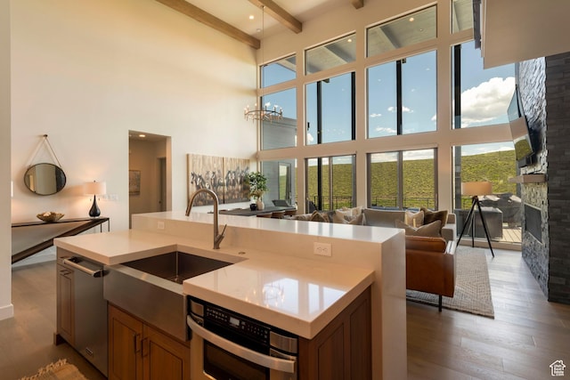 6650 Golden Bear Loop, Park City, UT 84098 - kitchen with a towering ceiling, open floor plan, light countertops, wood finished floors, and beamed ceiling