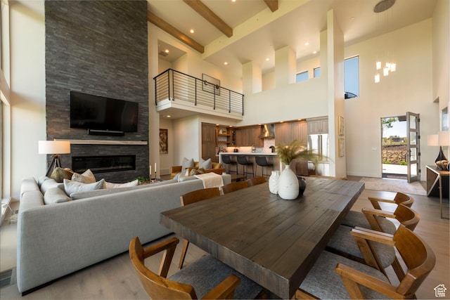 6650 Golden Bear Loop, Park City, UT 84098 - dining area featuring a high ceiling, a stone fireplace, light wood-type flooring, and beam ceiling
