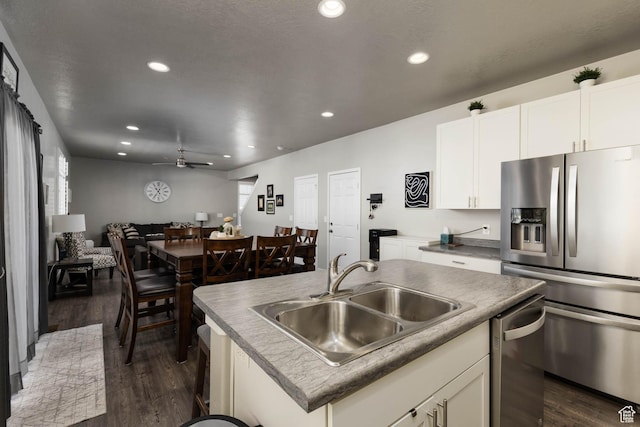7709 N Seabiscuit Rd, Eagle Mountain, UT 84005 - kitchen featuring stainless steel appliances, a sink, dark wood-style floors, recessed lighting, and open floor plan
