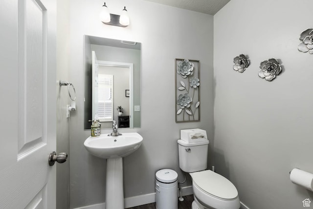 7709 N Seabiscuit Rd, Eagle Mountain, UT 84005 - bathroom featuring toilet, baseboards, and a sink