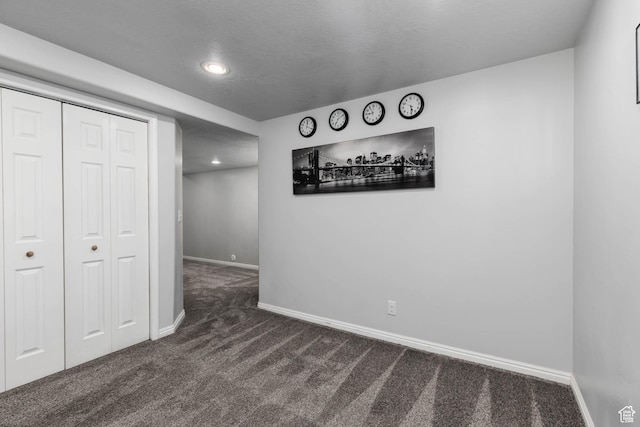7709 N Seabiscuit Rd, Eagle Mountain, UT 84005 - unfurnished bedroom featuring dark colored carpet, baseboards, recessed lighting, and a closet