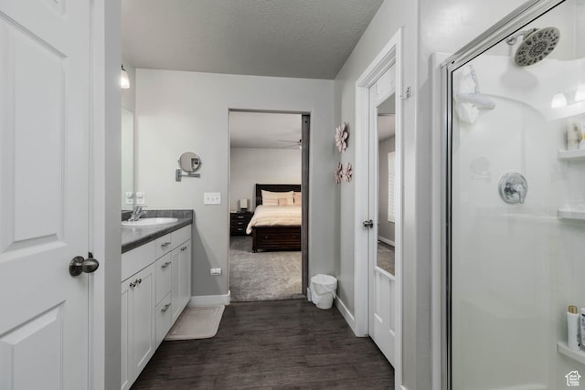 7709 N Seabiscuit Rd, Eagle Mountain, UT 84005 - bathroom featuring a stall shower, ensuite bathroom, vanity, wood finished floors, and ceiling fan