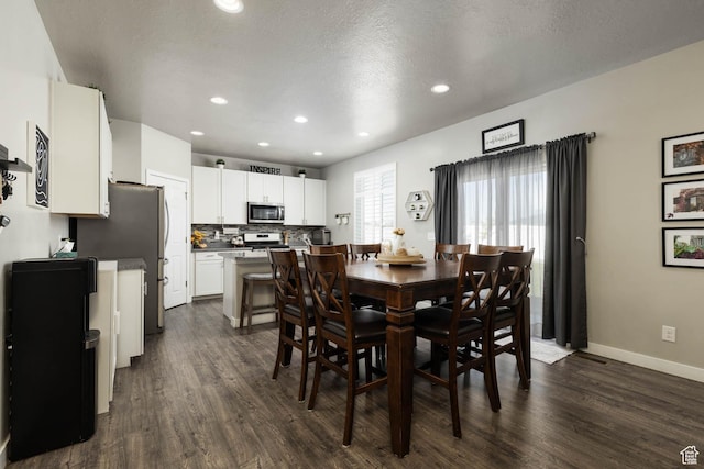 7709 N Seabiscuit Rd, Eagle Mountain, UT 84005 - dining area with dark wood-style floors, recessed lighting, and baseboards