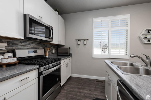 7709 N Seabiscuit Rd, Eagle Mountain, UT 84005 - kitchen with stainless steel appliances, a sink, decorative backsplash, dark wood-style floors, and baseboards