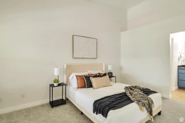 11738 S Currant Dr Unit 112, South Jordan, UT 84009 - bedroom featuring light colored carpet, baseboards, and connected bathroom