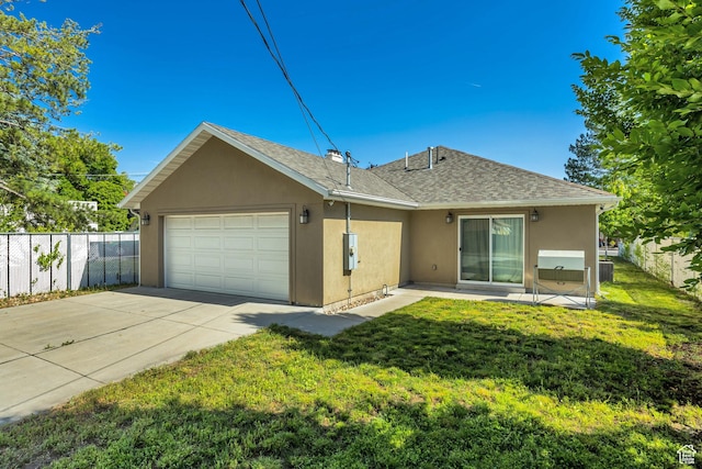 133 E Commonwealth Ave S, South Salt Lake, UT 84115 - back of property with stucco siding, an attached garage, driveway, and a shingled roof