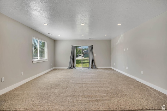 133 E Commonwealth Ave S, South Salt Lake, UT 84115 - unfurnished room with light colored carpet, recessed lighting, a textured ceiling, and baseboards
