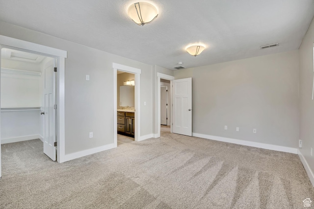 133 E Commonwealth Ave S, South Salt Lake, UT 84115 - unfurnished bedroom with light colored carpet, baseboards, and a spacious closet