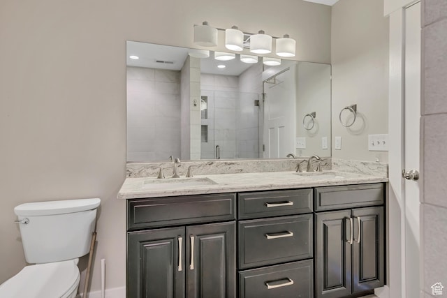 133 E Commonwealth Ave S, South Salt Lake, UT 84115 - bathroom featuring toilet, double vanity, and a shower stall