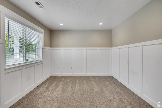 133 E Commonwealth Ave S, South Salt Lake, UT 84115 - carpeted spare room featuring a decorative wall, a textured ceiling, a wainscoted wall, and recessed lighting