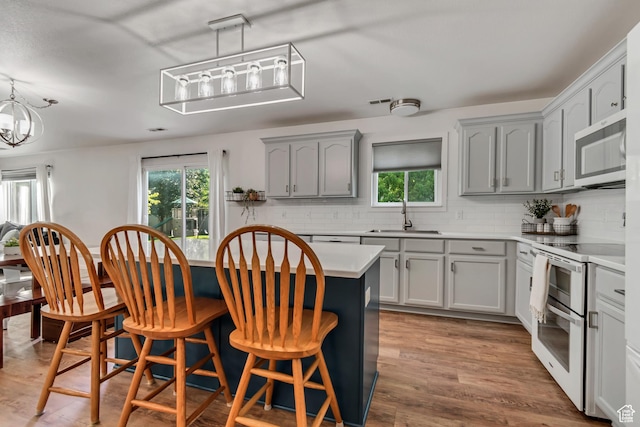 856 S 1580 W, Lehi, UT 84043 - kitchen with stainless steel microwave, double oven range, a sink, and plenty of natural light