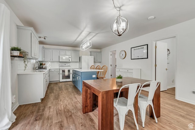 856 S 1580 W, Lehi, UT 84043 - dining room featuring light wood-type flooring, a chandelier, and baseboards