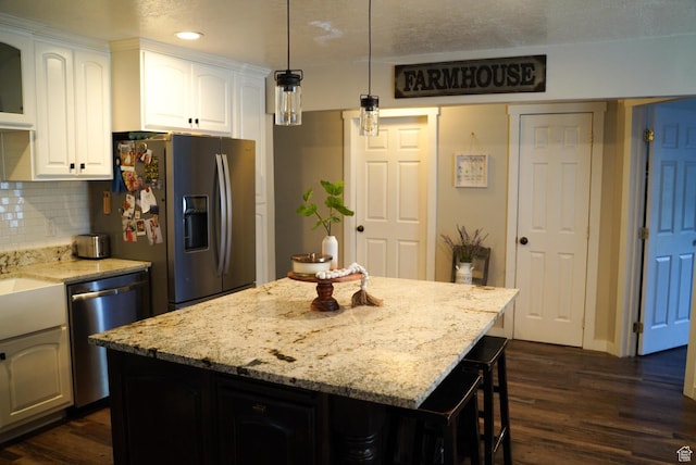 115 W 200 S, Wales, UT 84667 - kitchen with stainless steel appliances, dark wood finished floors, recessed lighting, white cabinets, and light stone counters