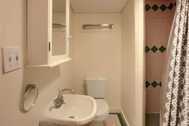 3600 S 6580 W, West Valley City, UT 84128 - bathroom with a sink, tiled shower, toilet, and baseboards